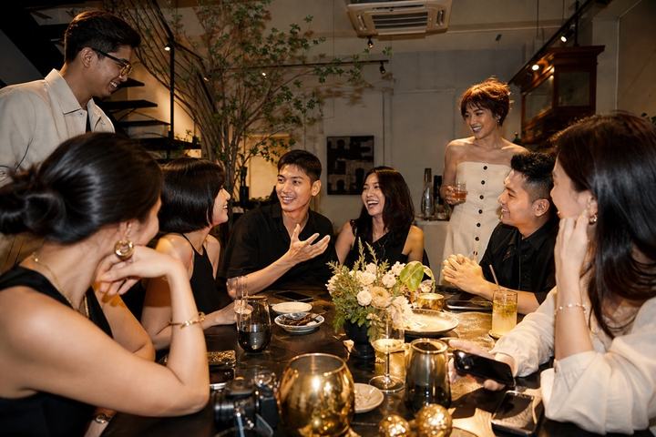 A diverse Singapore community exchanging ideas around a table